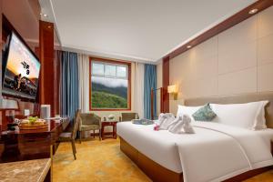 Postel nebo postele na pokoji v ubytování New Jiuzhai Hotel