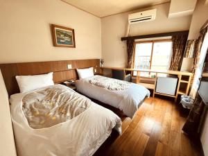 Postel nebo postele na pokoji v ubytování Izu-no-umi Hotel