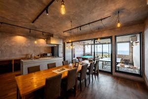 a kitchen and dining room with a table and chairs at taiza play in Kyotango