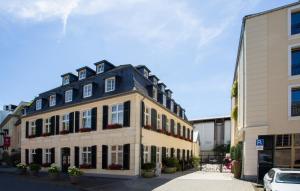 a large building with black and white trim at Classic Hotel Harmonie in Cologne