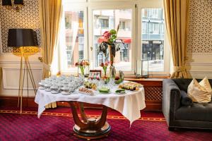 a table with glasses and food on it in a room at Hotel Kaiserhof Eisenach in Eisenach