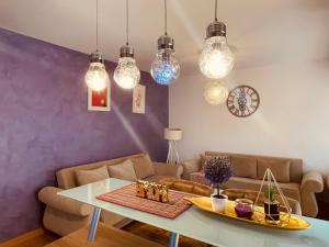 a living room with a table and a couch at Lavander Apartment W Pool and Private Beach in Tivat