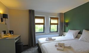 Postel nebo postele na pokoji v ubytování Hotel Bi-j Ons