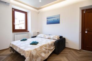 a bedroom with a bed in a room at Finestra Sul Borgo in Trevignano Romano