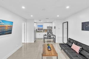 a living room with a couch and a table at Beach And Hard Rock Hollywood Vacation House Ha02 in Hollywood