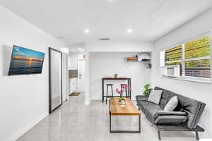 a living room with a couch and a table at New 2 Bed Studio Close To Beach & Casino Ha04 in Hollywood