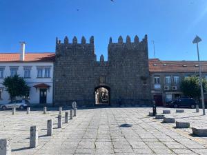 a large brick building with a gate in front of it at Vale do Gavim, Rua da Estrela in Trancoso