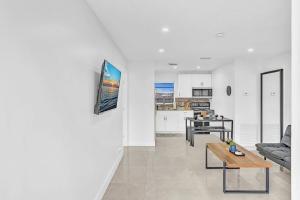 a living room with a couch and a table at Beach And Hard Rock Hollywood Vacation House Ha02 in Hollywood