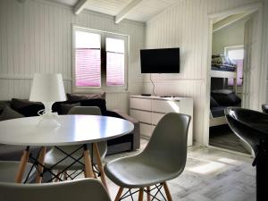 a living room with a table and chairs at Domki SILVER 3 in Jarosławiec