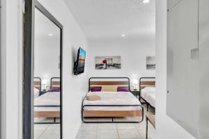 a bedroom with two beds and a mirror at Large 2 Bed Studio Close To Beach & Hard Rock Ha03 in Hollywood +36 photos