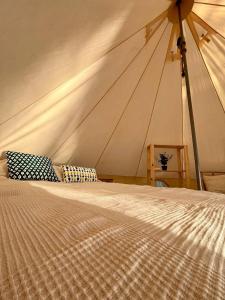 a large tent with a bed in a room at Alaska Glamping Linnansaari in Savonlinna +58 photos