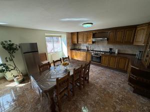 a kitchen with a table with chairs and a refrigerator at Casa de Mucha in Camariñas +16 photos
