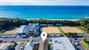 an aerial view of a parking lot next to the ocean at Ocean Echoes Coffs Harbour- Short walk to the beach, Cafes and clubs! in Coffs Harbour