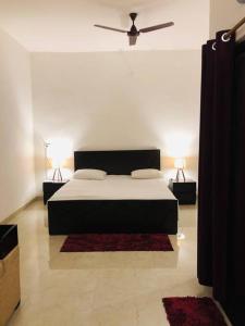 a bedroom with a bed with two lamps and a ceiling at Tattva 2 in Varanasi +20 photos