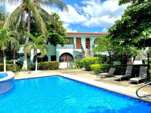 a swimming pool in front of a house at Coastal Comfort Spacious Second-Floor Getaway in Coco