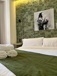 a bedroom with a bed with two towels on it at El Mantenío in Málaga