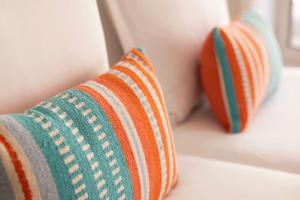 two colorful pillows sitting on a counter in a room at Grand Hotel Du Calvados in Paris