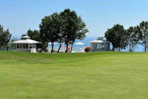 a golf course with two buildings on a hill at SeaView Golf Villa in Balchik