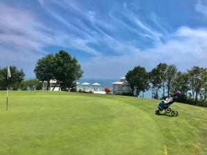 a baby in a stroller on a golf course at SeaView Golf Villa in Balchik