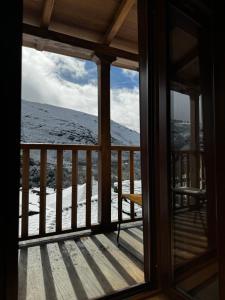 a window view of a snow covered mountain from a house at Lar da cima in Folgoso