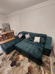 a green couch sitting in a living room at الساحل الشمالي in El Alamein +1 photo