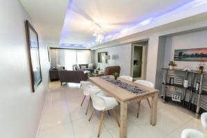 a dining room and living room with a table and chairs at The Pearls 2nd Floor Luxury Apartment in Port Elizabeth