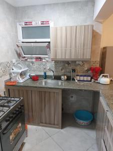 a kitchen with a sink and a stove at الساحل الشمالي in El Alamein
