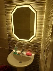 a bathroom with a sink and a mirror at الساحل الشمالي in El Alamein