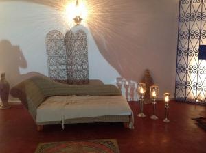 a room with a chair and candles on a wooden floor at Dar Salama in Bizerte