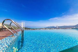 a swimming pool with a view of the water at Triple L Hotel Patong Beach Phuket in Patong Beach