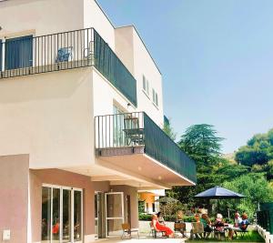 a group of people sitting in chairs outside of a building at Arte Oliva in Grebaštica +166 photos