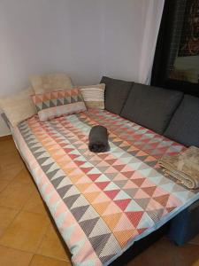 a bed with a hat on top of a couch at Villa Miraki Fuerteventura Surf Relax in La Oliva +33 photos