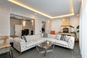 a living room with a white couch and a fireplace at Wolf Suites in Antalya