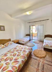 ウルツィニにあるDragovoja Lux Apartments & Roomsのベッドルーム1室(ベッド2台、ラグ2枚付)