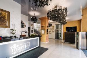 a store with chandeliers hanging from the ceilings at Hotel Marttel in Karlovy Vary +60 photos