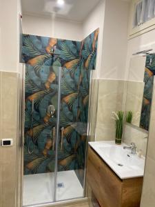 a bathroom with a shower and a sink at La Petite Maison in Naples +32 photos
