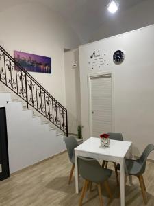 a dining room with a table and a staircase at La Petite Maison in Naples