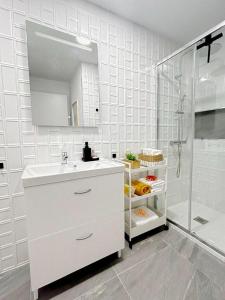 a white bathroom with a sink and a shower at D'Sal y Arena in Breña Baja +10 photos