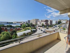 a balcony with a view of a city at Apartment 1 Plisi Gjilan in Gnjilane
