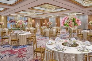 a ballroom filled with tables and chairs with flowers at Mandarin Oriental, Jakarta in Jakarta +37 photos