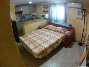a small room with a couch and a bed at Miguel y Rosa in Tíjola