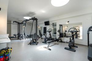 a gym with several treadmills and exercise bikes at Mangia's Pollina Resort in Cefalù
