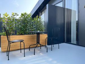 two chairs and a table on a balcony with plants at AG Hotels Antalya in Antalya