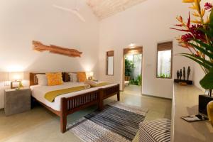 a bedroom with a bed and a living room at Nirbana Retreat in Ahangama +26 photos