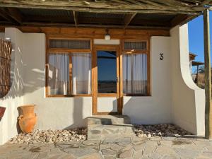a front door of a house with a window at Wüstenquell Lodge in Arandis