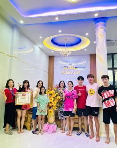 a group of people posing for a picture in a room at Homestay SUNA Tuy Hòa, Phú Yên in Tuy Hoa