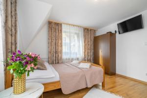 Posteľ alebo postele v izbe v ubytovaní Apartament u Kostka