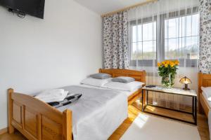 Posteľ alebo postele v izbe v ubytovaní Apartament u Kostka