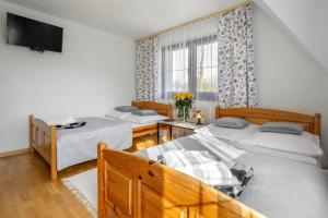 Posteľ alebo postele v izbe v ubytovaní Apartament u Kostka
