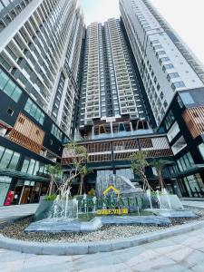 a fountain in front of some tall buildings at Căn Hộ cao cấp The Emerald Golf View Thuận An Bình Dương in Thuan An